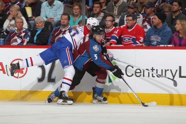 DENVER, CO - NOVEMBER 2: Nate Guenin #5 of the Colorado Avalanche controls the puck as Max Pacioretty #67 of the Montreal Canadiens reaches over his shoulder at the Pepsi Center on November 2, 2013 in Denver, Colorado. (Photo by Michael Martin/NHLI via Getty Images)